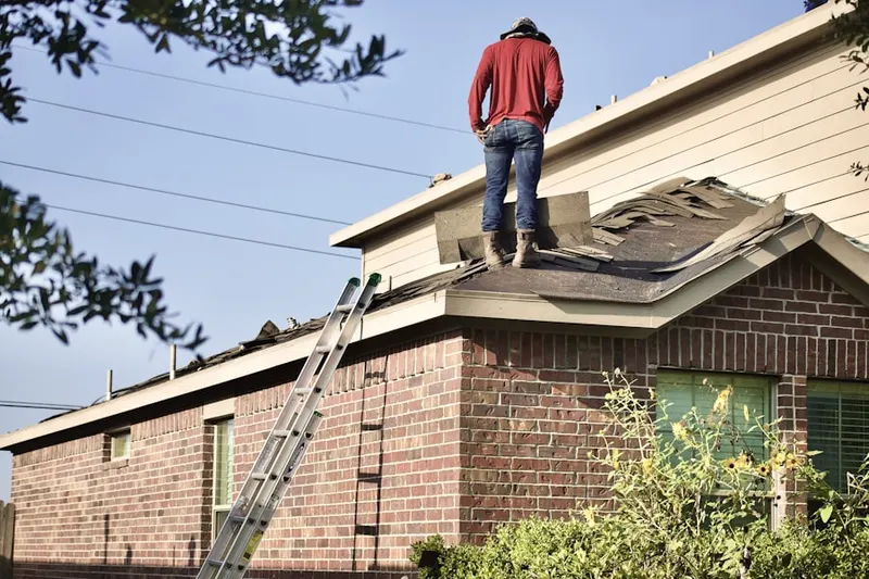 Professional roofer working on a residential roof in Potters